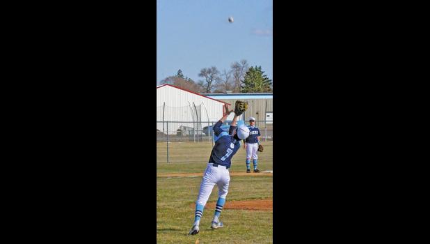 FIRST BASEMAN ZACH WENNER pulled in this soft fly in the infield from a game a few weeks ago. Wenner had a hit and an RBI in Becker’s only win this week against Milaca. (Photo by Bill Morgan).