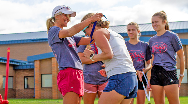 Shannon Nuest, race volunteer, gives female winner Sara Laugen her medal. (Submitted photo.)