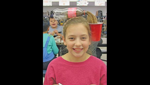 CLEARVIEW FIFTH-GRADER LAUREN G.’S long hair came in handy when creating her hairstyle for Wacky Hair and Hat Day at Clearview, one of the school’s daily themes celebrating American Education Week. (Photo by Penny Leuthard)