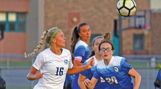 Adeline Kent kept her eye on the ball as she tried to evade Big Lake’s Halle Holman (#20) during Monday’s match. (Submitted Photo).