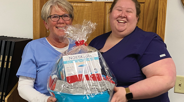 WINNER of the snow cone maker basket (donated by Patriot Newspaper) from the Big Lake Community Fair last Saturday is Lynn Wynne (L) of Keller Lake Commons. Wynne is planning to leave the snow cone maker in the activity room to share with the residents. Pictured with Wynne is Housing Director, Nicole Gilder (R). (Patriot Photo by Kathy Nelson)