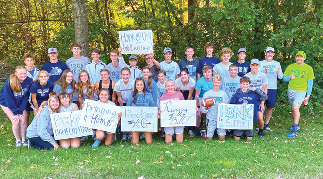  The boys and girls crosss country teams stopped for a photo opportunity before starting their annual homecoming run to bring the game football back to Eppard Field. (Submitted Photo)