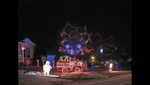 CHAD KOREN AND KARI MECHTEL’S Clear Lake synchronized-to-music light show features a fire truck made of lights. Koren and Mechtel are Clear Lake firefighters; all money raised from their light show is donated to the department. (Photo by Penny Leuthard)