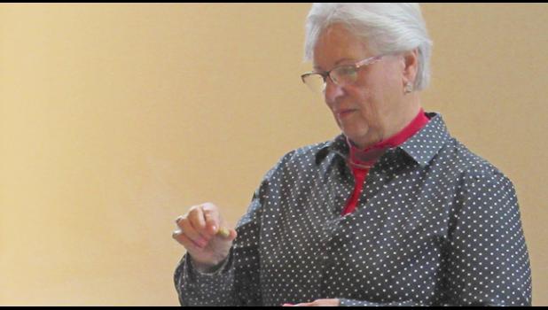 CALLER JANE GOHMAN reads a just-pulled bingo number during Young at Heart’s grocery bingo event last week. (Photo by Penny Leuthard)