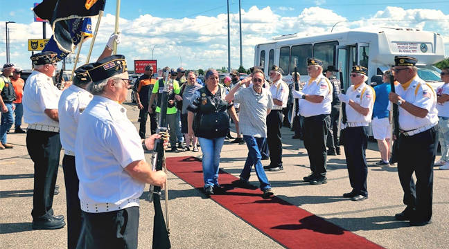 A VETERAN SALUTES THE FLAG (left) as he is escorted down the red carpet and into the celebration. (Submitted photo.)
