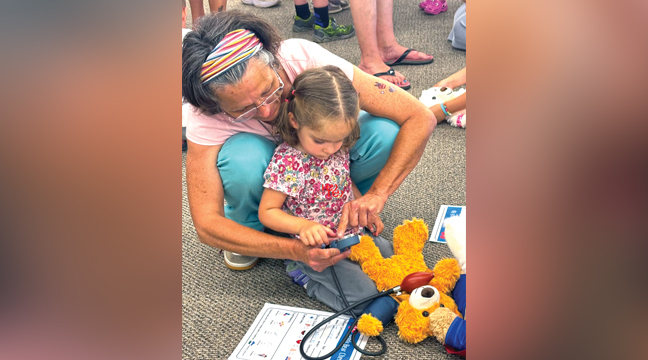 TARA L. HELPS HER GRANDDAUGHTER Ivory L. check her bear’s blood pressure