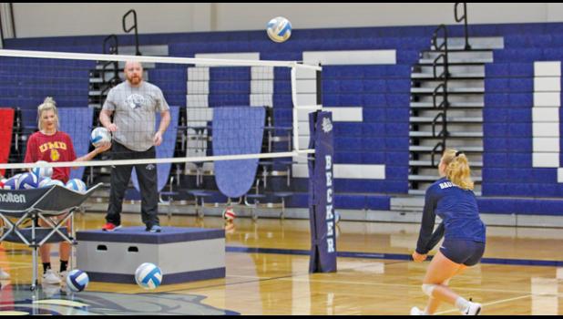 COACH GREG LYNCH (L) served shots to his players during their Thursday morning workout in the BHS gymnasium.