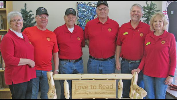 CLEARWATER LIONS Jane Gohman, Pete Kroeplin, Doc Gohman, Jack Kuechle, President Ken Abraham and Mary Abraham with the bench their organization donated to the Clearwater Library. (Photo by Penny Leuthard)