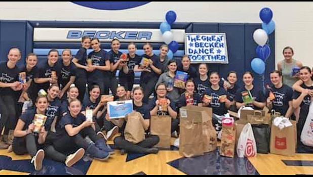 DANCERS SHOW OFF some of the food shelf items collected during their Great Becker Get Together show last Friday. (Submitted Photo)