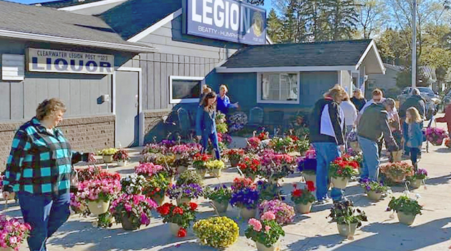 COMMUNITY MEMBERS TRY TO DECIDE which of the many varieties of plants to take home with them during the Clearwater Legion Riders’ annual plant sale. (Submitted Photo)