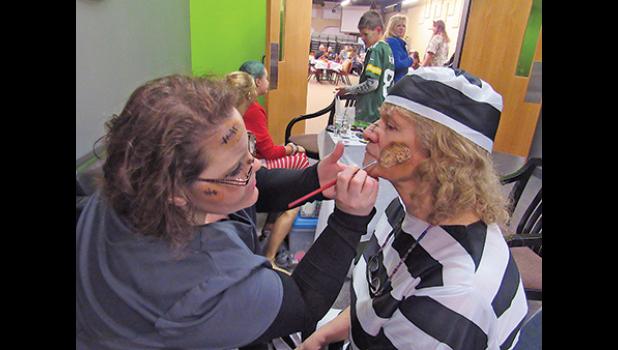 ASHLEY HASKIN puts the finishing touches on inmate Carol Gulbranson’s new scar.