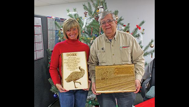KELLY DOMBROSKE (L) posed with Dork the Emu’s dad, Tom Berry (R) and the two plaques she had made featuring a photo of Dork and a poem. (Photo by Bill Morgan).