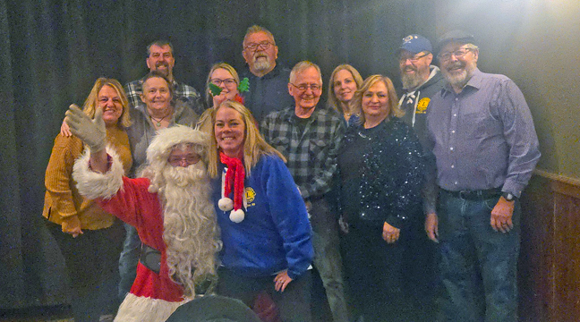BECKER LIONS SPREAD HOLIDAY CHEER. Pictured: Jim, Sue and Sydney Stang, Steve and Beth Rosa, Kurt Anderson, Connie and Tim Adelman, Roger Aker and Angie Johnson (pictured on Santa’s lap). (Patriot Photos by Mary Nehring).