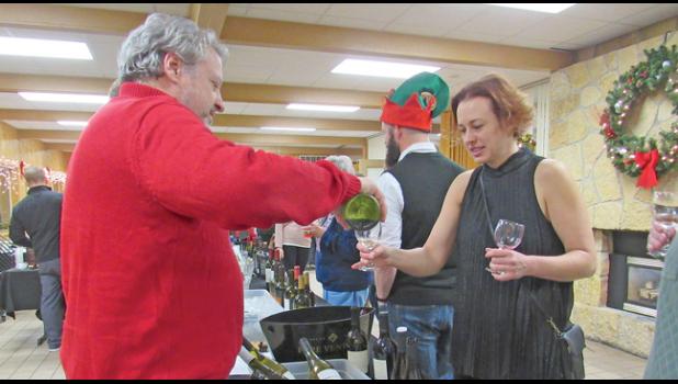 GUESTS AT CAMP FRIENDSHIP’S HOLIDAY PARTY Friday night were able to try out a variety of beer, wine and liquor. (Photo by Penny Leuthard)