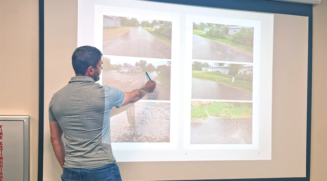 ROAD ENGINEER KEVIN KRUGER showed the Orrock Town Board where residents were experiencing drianage issues on their road, and discussed potential solutions. (Patriot Photo by Katherine Cantin.)