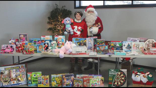 Santa and his helper were ready to start handing out toys to kids at the Clearwater-Clear Lake Food Shelf Monday afternoon. (Photo by Ken Francis.)