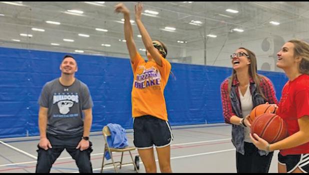 MADISON BASS’ SUPPORTERS CHEER HER ON as she shoots another free throw during her fundraiser. (Submitted Photo)