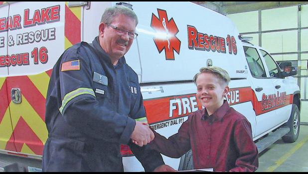 CLEAR LAKE FIRE CHIEF RON KOREN presents A. J. Riservato with a Citizens Lifesaving award last January. (Photo by Penny Leuthard)