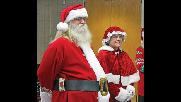 MR. AND MRS. SANTA CLAUS were on hand Tuesday to meet and greet families attending the dinner. 