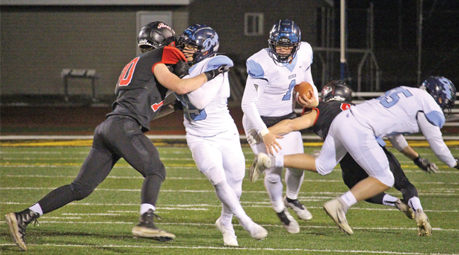 CARTER CALLAHAN (with ball) navigated the Spartan defense and amassed 141 yards on the ground and two TDs in Becker’s loss last week. (Submitted Photo).