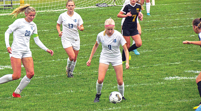 EIGHTH GRADER STELLA BLOCK (#9) looks to move the ball in the match against Hutchinson Oct. 1. Block had an assist on one of the two goals scored that night. (Submitted Photo).