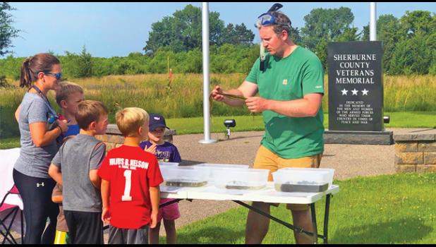  SHERBURNE SWCD Water Resources Specialist Dan Cibulka holds a northern water milfoil plant that is native to our area lakes.  Of the 20 different plants he demonstrated, only two of them are non-native. (Photos by Gloria Vande Brake).
