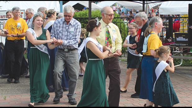 VISITING ROYALTY joined in with the square dancers near the swimming area (above). 