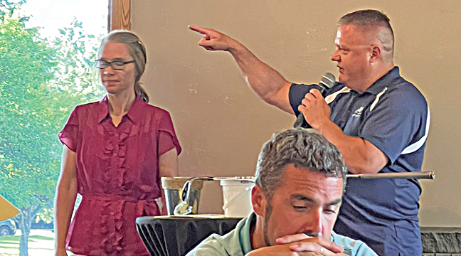 MAUREEN BATY (back left) and Jason Hammerback (back right) of GRFIA were the hosts and presenters of the golf scramble event Monday. They awarded prizes and gave instructions to the golfers where they could pick up prizes, buy drinks and enjoy a superb buffet meal. (Patriot Photo by Bill Morgan)