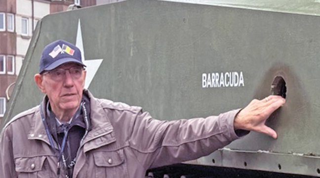 HENRI, Belgian tour leader, showing an American tank which met its fate in an encounter with German forces. (Photo Submitted)