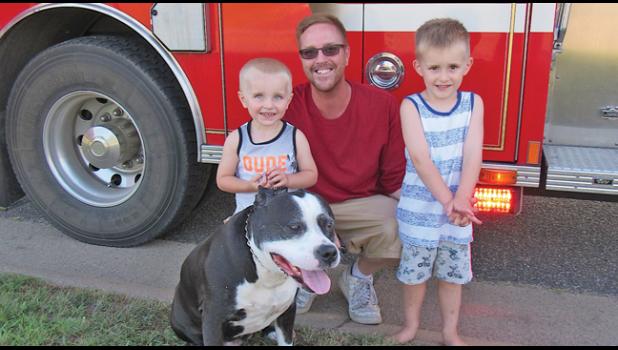 CLEAR LAKE RESIDENTS two-year-old Maverick, dad Derek, four-year-old Odin and dog Elmo attended the Hunter Lake Bluffs Night to Unite block party. (Photo by Penny Leuthard)