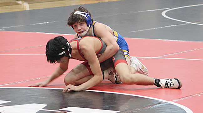 Cash Sixberry of the Hornets has a tight hold on Monticello’s Anthony Perez before pinning him at 1:16. Sixberry took the 113-pound section title.. (Photo by Ken Francis.)
