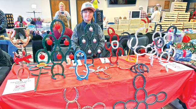 ONE OF THE BOOTHS AT CHRISTMAS CENTRAL  featured Asher Quamme who, along with his brothers Aleck and Aidan, welded up cute Christmas décor out of horseshoes. (Submitted Photo)