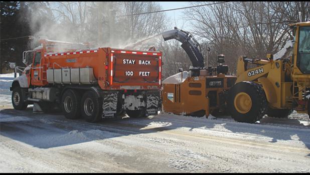 County road maintenance crews have been dealing with huge piles of snow on the sides of the roads. Last week they began hauling snow to different spots in the county to make more room on the streets and allow more visibility at intersections. (Submitted Photo.)