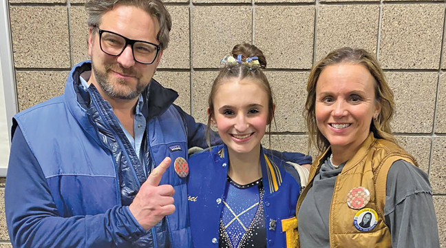 BIG LAKE SOPHOMORE GYMNAST LOLA VISCI had the top score of 9.5750 on uneven bars at state last weekend. Above, she poses with her proud parents, Amy and Fred. (Submitted Photo).