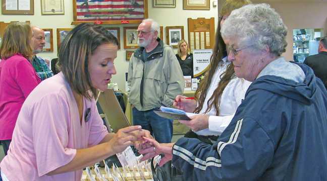 JACKIE WIPPER from Jazzy Nails with Jackie demonstrates one of her products to an expo attendee in 2019. (Archive photo by Penny Leuthard).