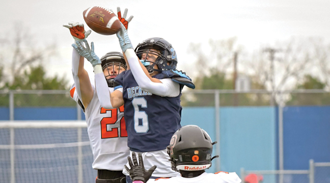 WR Cayden Goodell leapt between two Tiger defenders to reel in this pass from QB Kowalkowski. (Submitted Photo by Anne Koste).