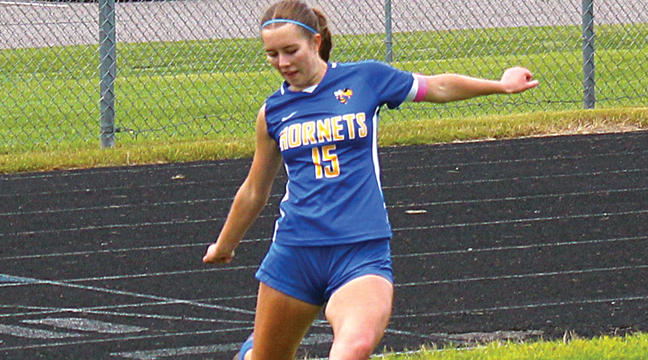 Adeline Hitter takes a corner kick in a game earlier this season. Hitter had a goal and three assists in Big Lake’s past five games. (Patriot Photo by Ken Francis.)
