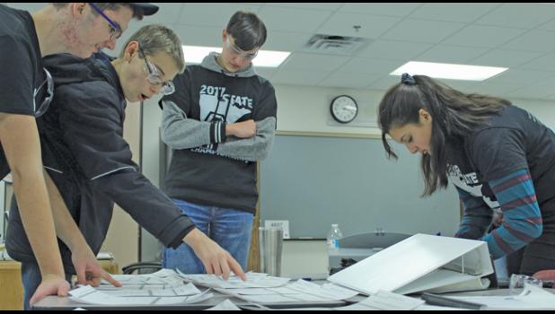 MEMBERS OF THE BUILD DEPT. look over concepts and designs for this year’s robot. (Submitted Photo)