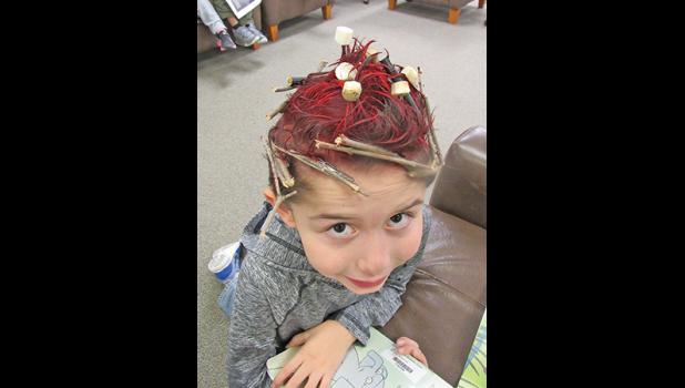 CLEARVIEW FIRST-GRADER DANIEL S. really thought out of the box when coming up with his wacky hair style to celebrate American Education Week, asking his aunt to turn his hair into a campfire with marshmallows roasting over it. (Photo by Penny Leuthard)