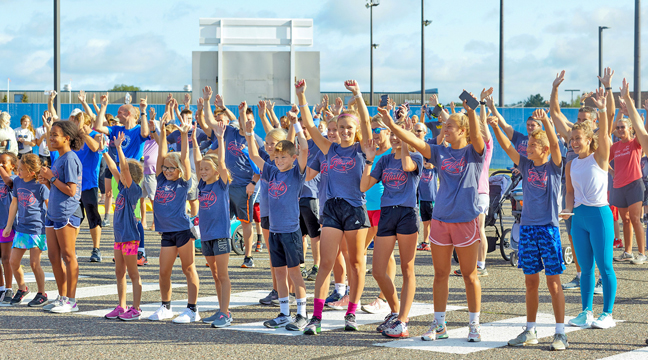 RUNNERS GATHERED in the Becker Schools’ parking lot for the 11th annual Haitian Hustle. (Submitted photo.)