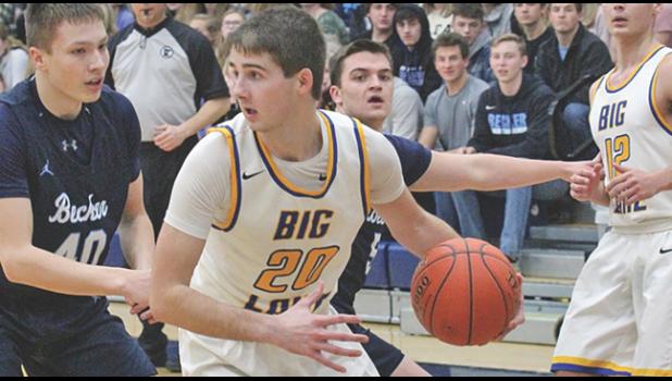 BIG LAKE’S MITCHELL SPANIER (#20)  looked to pass the ball after reeling in a rebound. Becker’s Brady Paumen (#40) and Josh Fobbe (back) defend the play. (Photos by Bill Morgan).