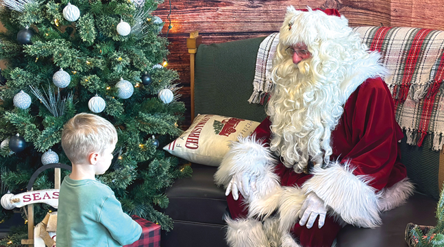  Lincoln approached Santa Claus cautiously. (Patriot Photo by Don Bellach).