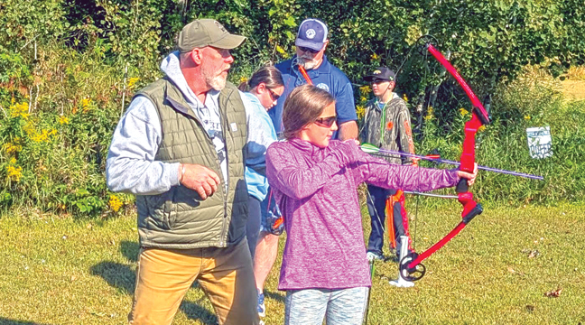 USA Director of Field Operations Kevin Grubbs and Event Coordinator David Pollard assist youth archers at a station on Saturday, Sept. 8. Volunteers represented the USA and different trades. (Submitted Photo).