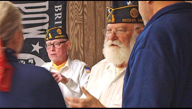 LEGION COMMANDER JOHN RIEBEL speaks with guests at the 100 year anniversary celebration of the Becker American Legion. (Photo by Penny Leuthard)