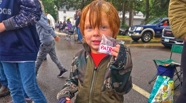 Trace Phillipi, Clear Lake, didn’t let a little rain dampen his mood at Palmer Day parade last Saturday, September 6. (Patriot Photo by Mary Nehring. )
