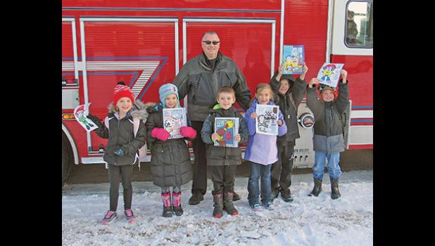 By Penny Leuthard,  Staff Writer  Twelve excited Becker Primary School students received a ride home in a firetruck after winning a coloring contest held by the Becker Fire Dept. Each fall during Fire Prevention Week the students are given tours of the fire station along with a presentation on fire safety. They’re also given coloring sheets with fire safety tips on them to color and submit to the coloring contest the department holds. Becker firefighter and Public Safety Officer Ron Kortz chooses four winne