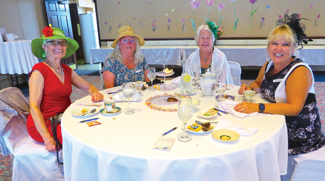 KATHY LANGVA, KATHY MATHIASEN, Shirley Hanson, and hostess Susan Paulsen visit during the Clearwater Estates Ladies Tea. (Submitted Photo)