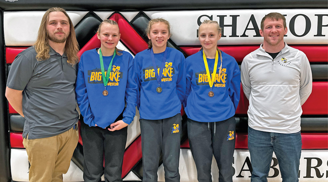 BIG LAKE’S three female wrestlers posed with their coaches. Left to right: Cole Sixberry, Graysen Mayer, Alexa Guy, Cora Rand and Matt Nelson. (Submitted Photo).
