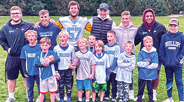 Thursday after the Bulldog team supper, some Becker Youth football players were surprised by a visit from some of the varsity football players. (SUbmitted Photo)