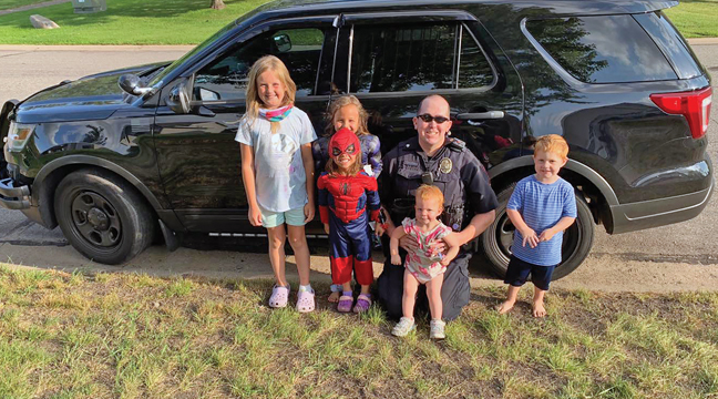 BLPD SGT. TOM KUCALA gathered around the youngsters who donated over $100 to the BLPD during their lemonade and bracelet stand. (Submitted Photo).